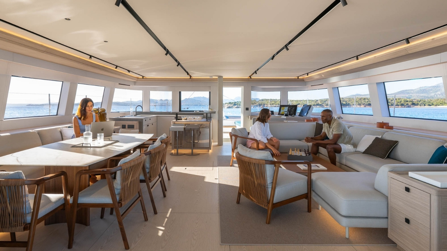 Interior dining table of the Lagoon EIGHTY 2 catamaran set for a shared meal on board
