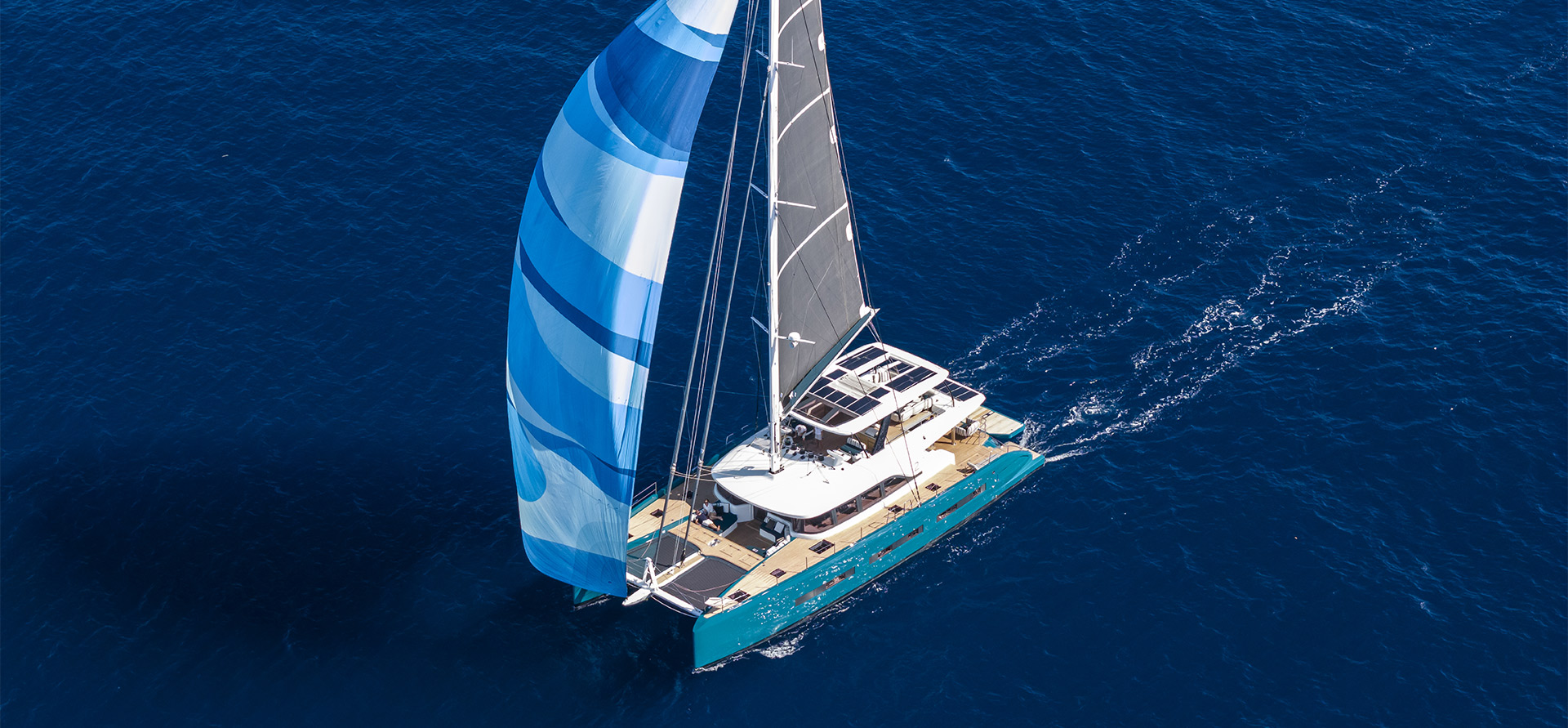 Lagoon EIGHTY 2 catamaran sailing under blue gennaker across the open ocean